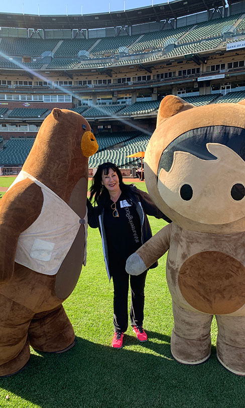 Lisa with life-size Salesforce characters at Oracle Park in San Francisco